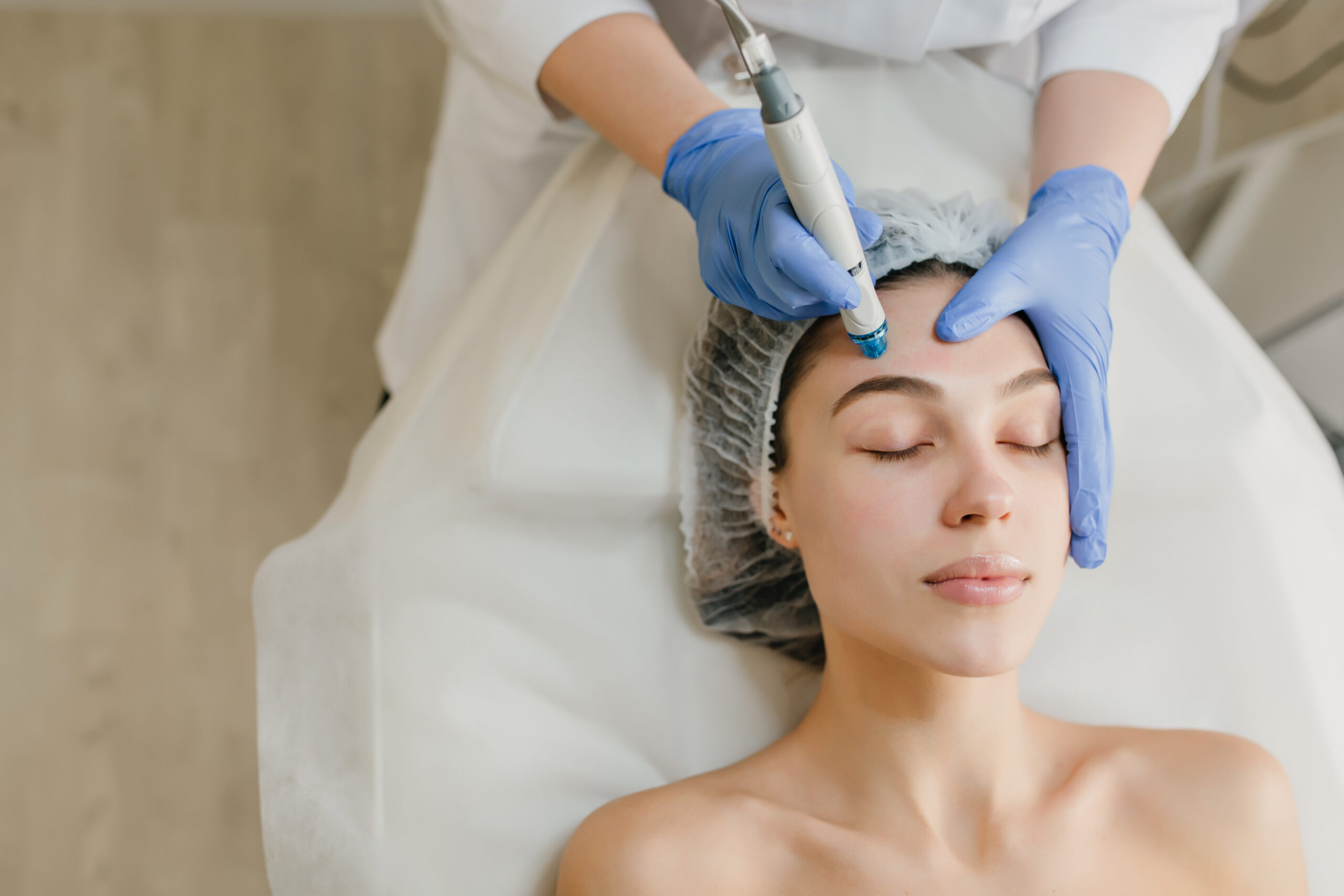 View from above of beautiful woman enjoying cosmetology procedures, rejuvenation in beauty salon. Dermatology, doctor at work, healthcare, therapy, botox. Place for text